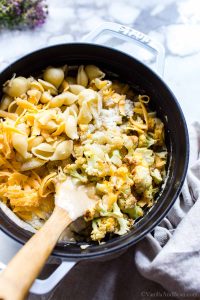 Dutch Oven Mac and Cheese with Cauliflower and a wooden spoon in the dish.