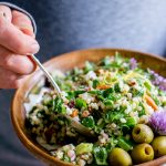 This Spinach Pecan Brown Rice Salad with Feta in a bowl with a spoon digging in.