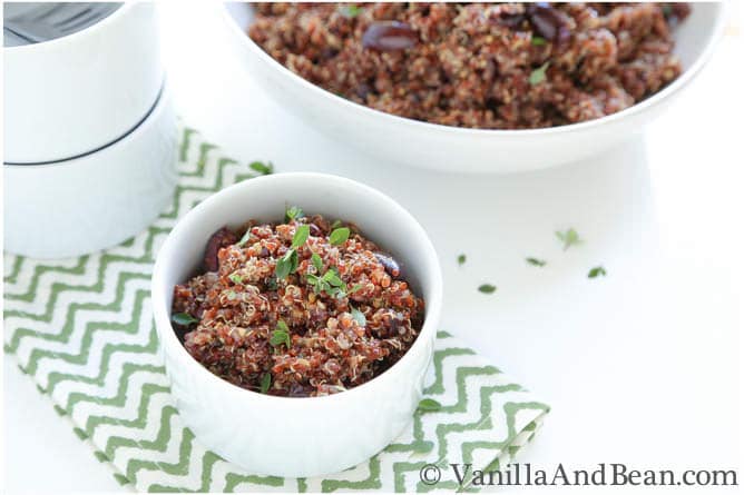 A small bowl and a serving bowl of roasted eggplant and quinoa salad