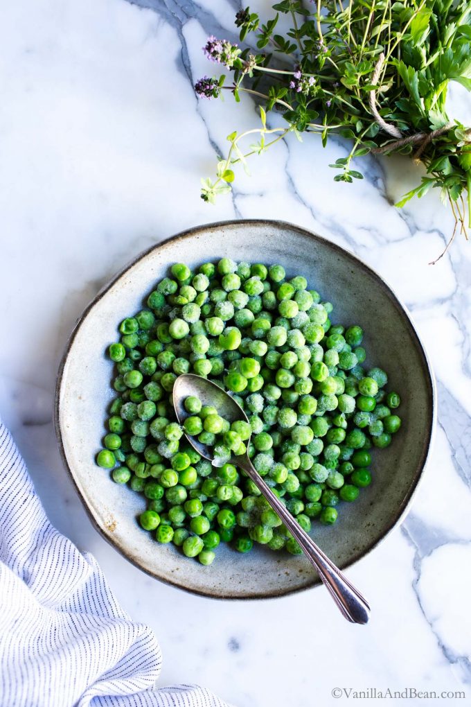Frozen Peas in a Bowl with a spoon.