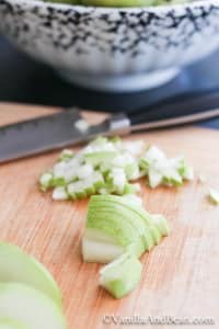 Pear diced on a chopping board with knife