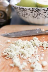 Blue cheese chopped on a board with a knife