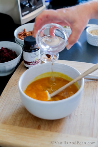 Liquid ingredients in a white bowl with a spatula