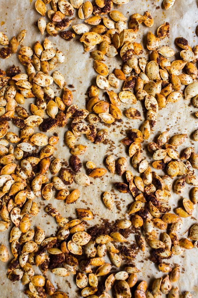 Homemade roasted pumpkin seeds on a sheet pan. 
