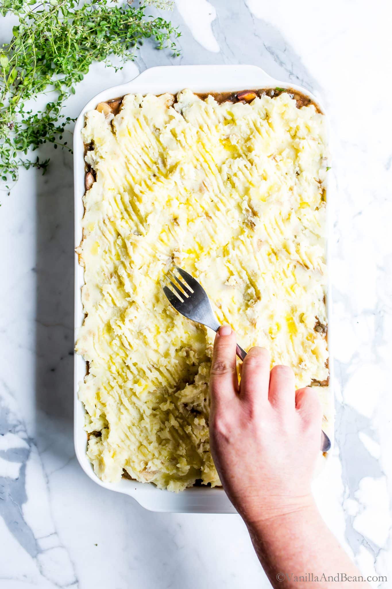 Top the casserole with the mashed potatoes and run a fork over the top for decoration. 