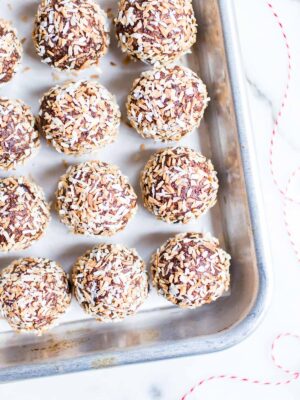 Chocolate Coconut Date Balls on a sheet pan.