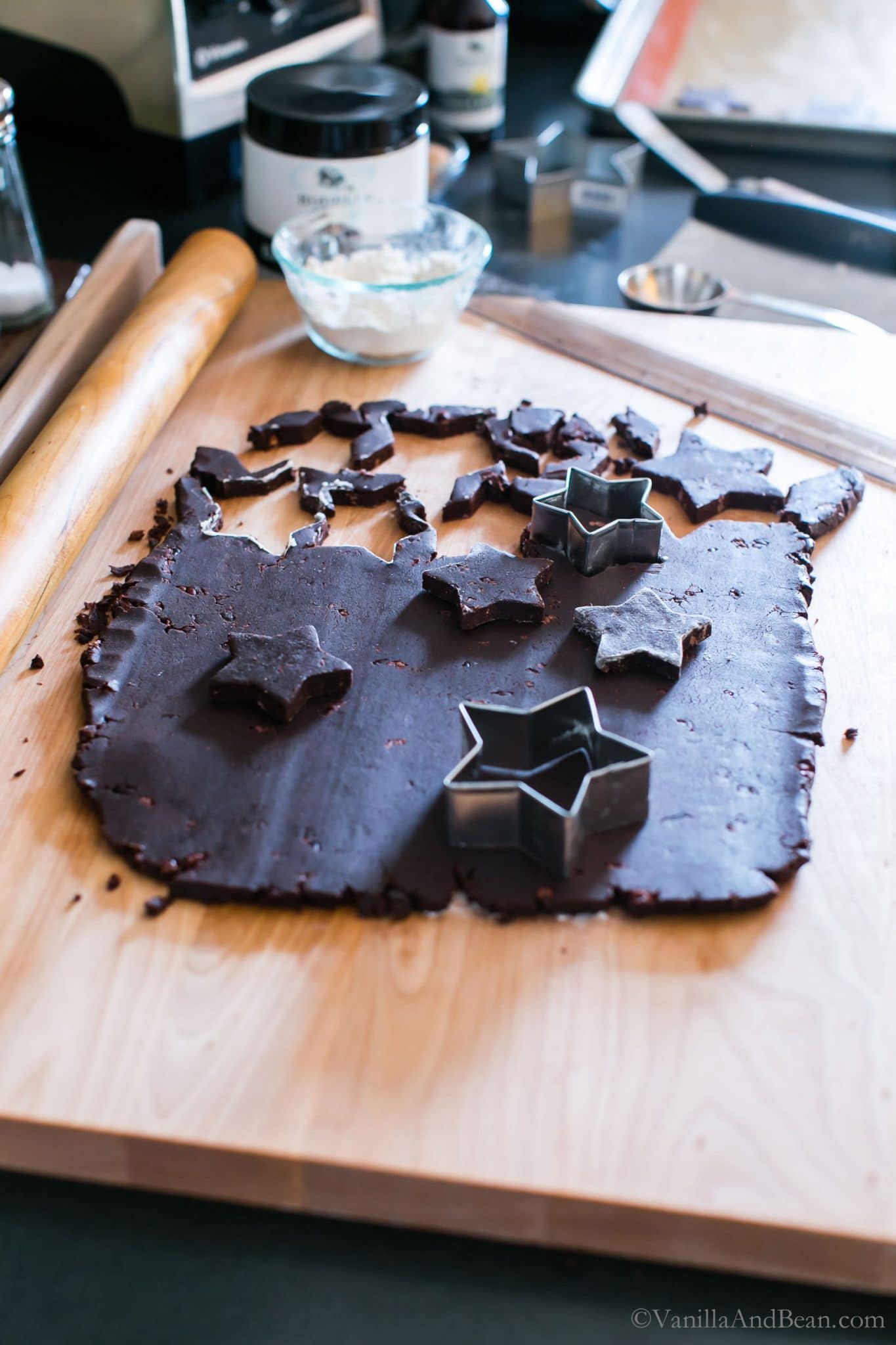 Cutting dark chocolate shortbread with cookie cutters.