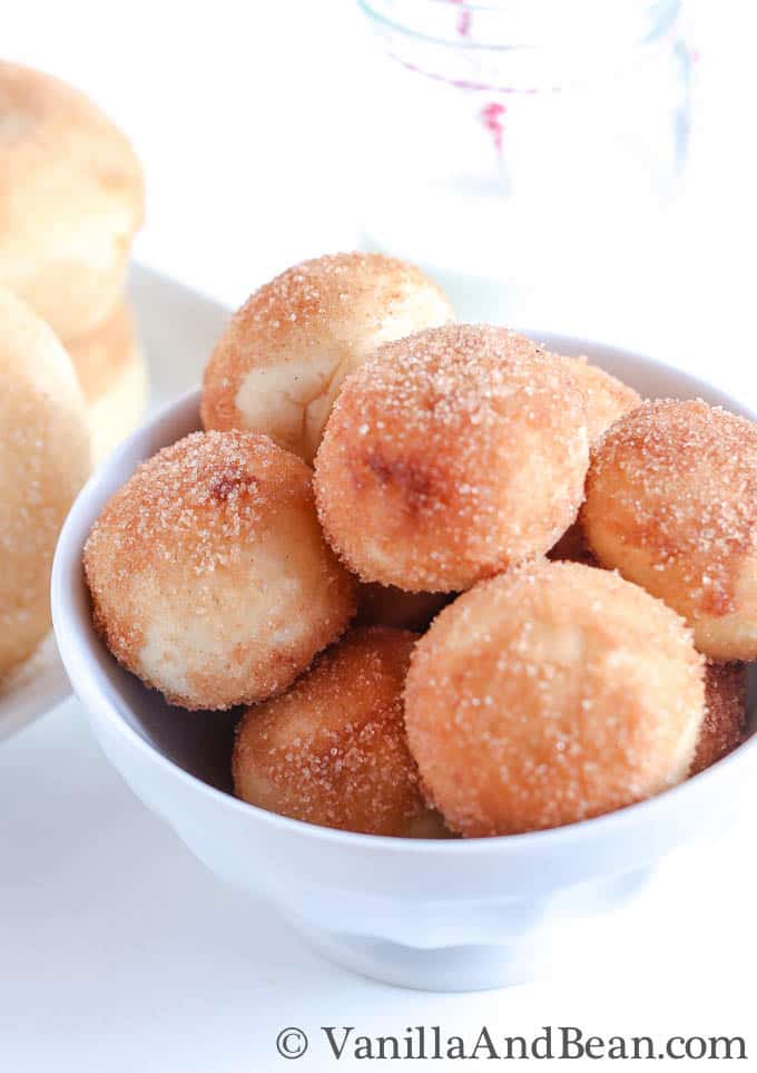 Baked doughnuts in a bowl with cinnamon sugar topping.