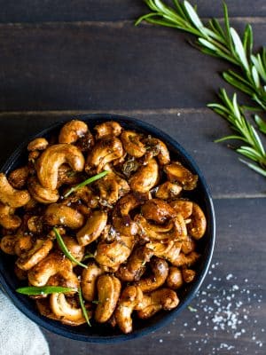 Sweet and Spicy Maple-Roasted Rosemary Cashews in a bowl ready for snacking.