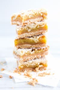 A layer of Orange Crumble Tart squares surrounded by a few crumbs.