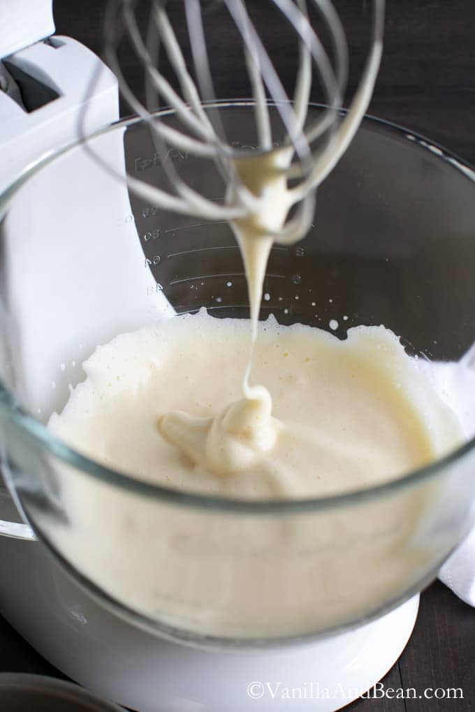 The egg mixture is thick and frothy on a whisk attachment and in a bowl of a stand mixer.