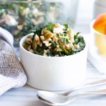 A small bowl of Farro, Kale and Olive Salad with Citrus Vinaigrette.