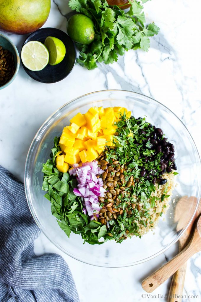 All the ingredients for Black Bean Quinoa Mango Salad in a bowl.