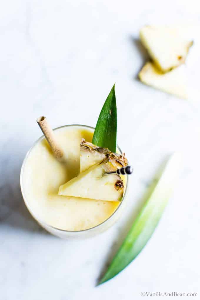 Fresh Pina Colada in glasses garnished with fresh pineapple.