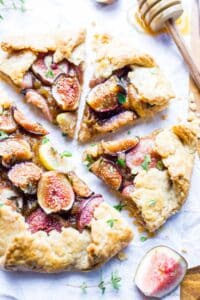 Sliced savory fig and goat cheese galette on a cutting board.