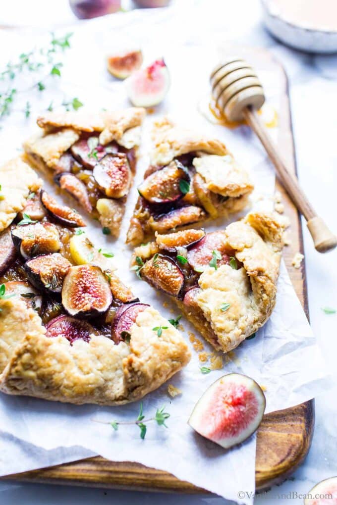 Sliced goat cheese and fig galette on a cutting board.