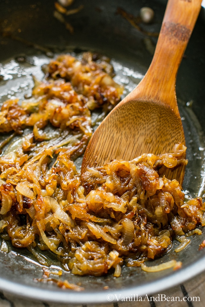 Caramelized Onion in a pan with a spoon. 