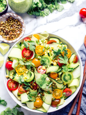 Raw Zucchini Ribbons Salad with corn and tomatoes in a bowl ready for serving.