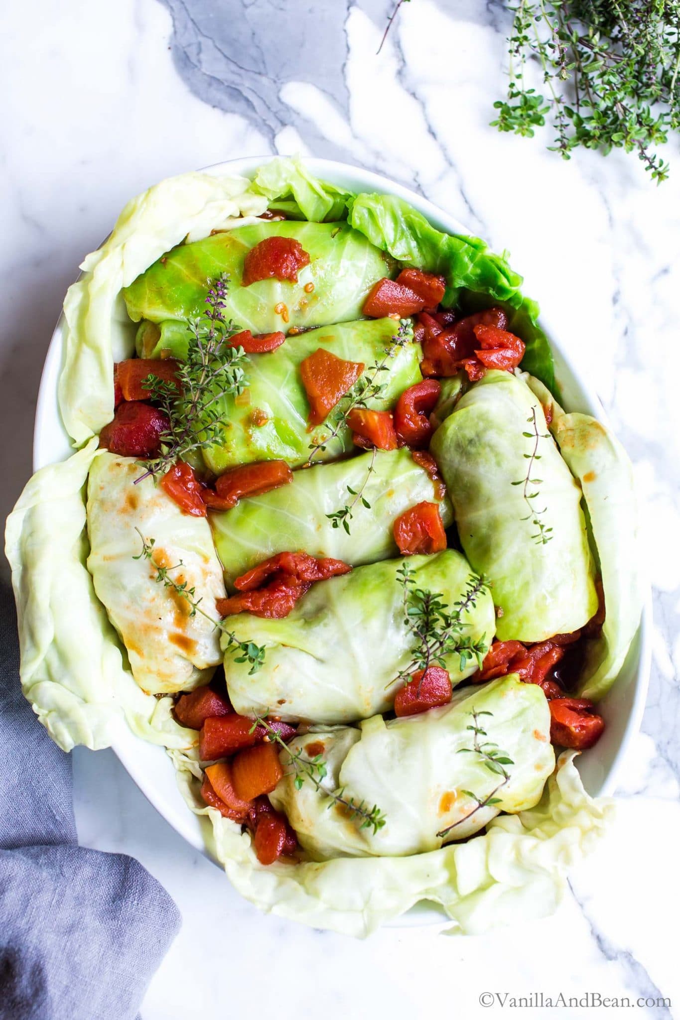 Vegan cabbage rolls in a baker ready to bake.