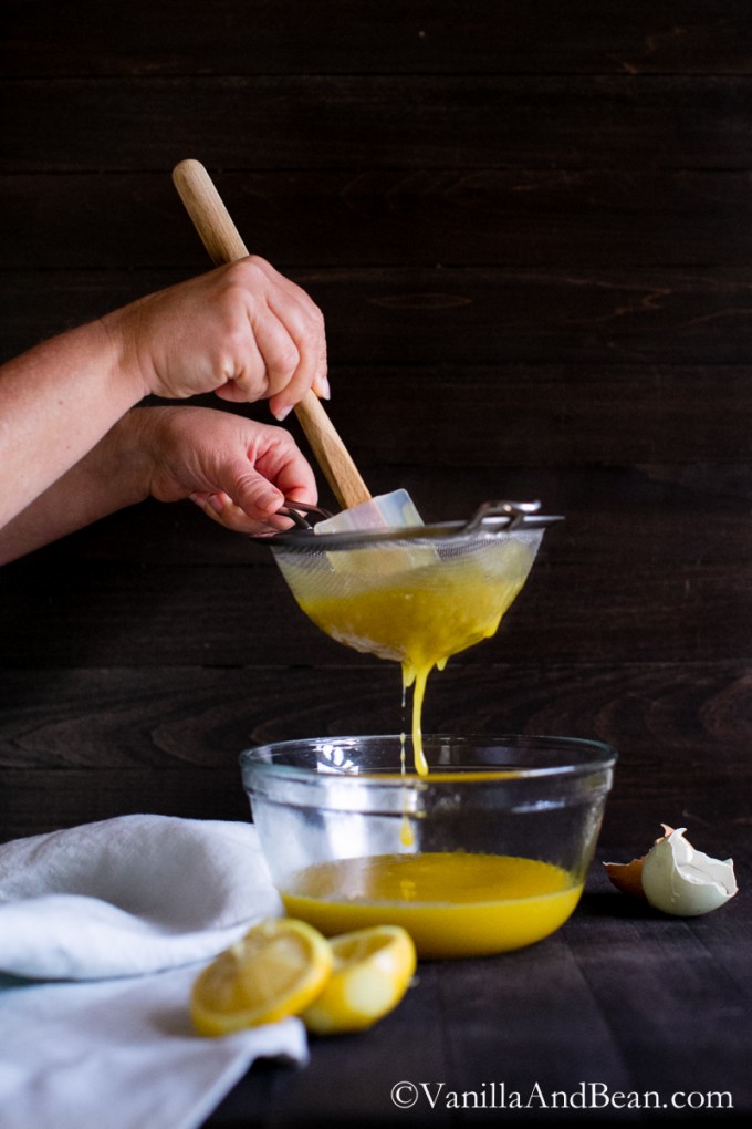 Straining the lemon curd into a bowl. 
