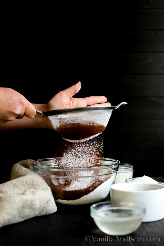 Sifting cocoa powder and flour into a bowl. 