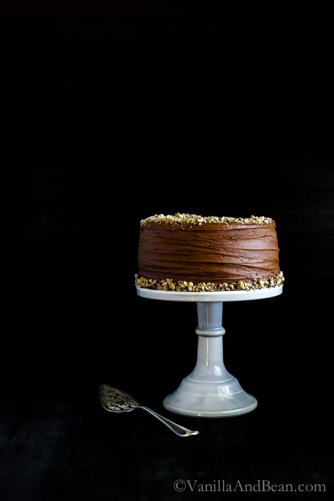 Vegan Chocolate Hazelnut Cake with Whipped Ganache on a cake stand. 