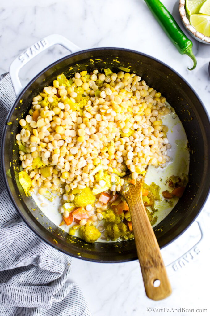 Chana Dal Recipe with cauliflower, cashew and coconut milk cooking in a Dutch oven.