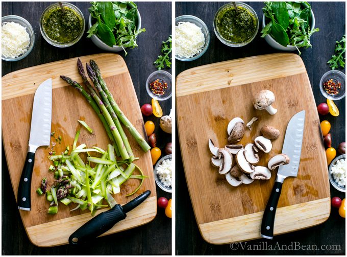 Sliced asparagus and mushrooms on a cutting board. 