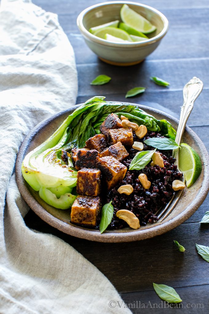 Spicy Peanut Tofu Bowl with Coconut Forbidden Rice in a bowl with a fork ready to eat. 