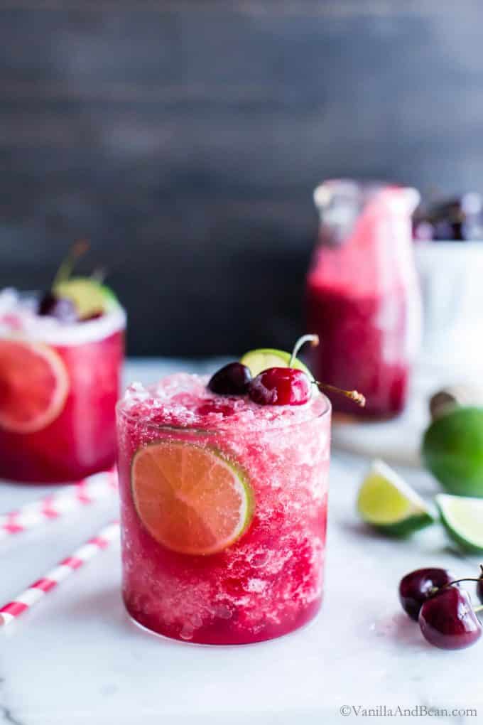 Cherry Limeade Recipe made with honey and club soda in a glass garnished with cherries and lime. 
