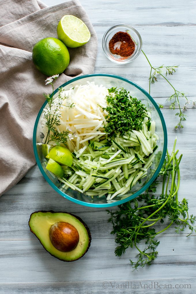 Ingredients in a bowl and sliced for Avocado Jicama Cucumber Salad ready for tossing. 