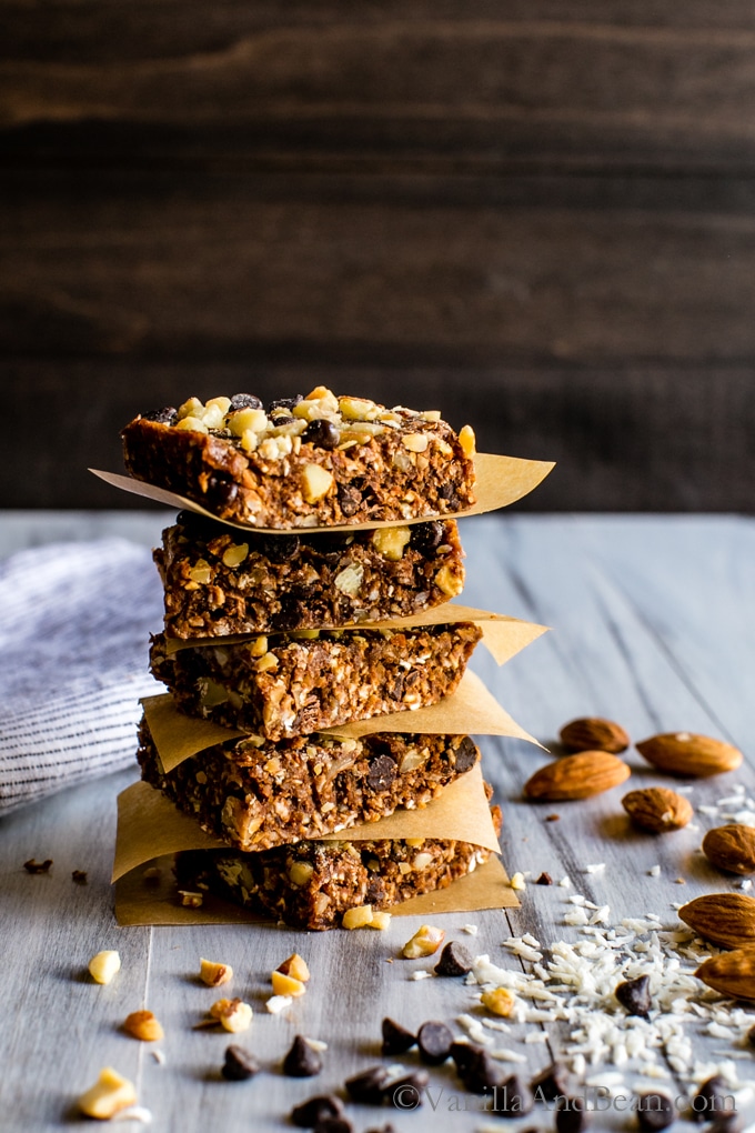 No Bake Vegan Chocolate Almond Coconut Bars stacked tall and ready for sharing. 