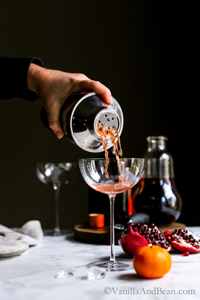 Pouring winter punch into a cocktail glass. 