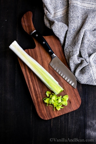 Chopping leeks on a cutting board. 