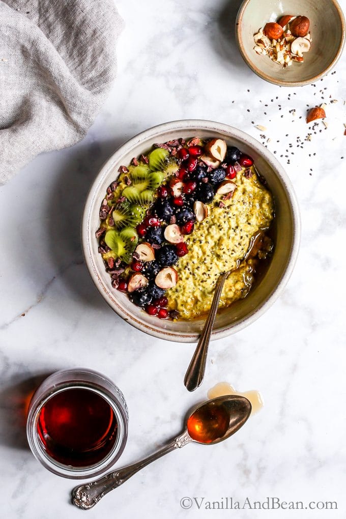 Overhead shot of overnight Turmeric Chia Oats in a bowl with a spoon ready for sharing. 