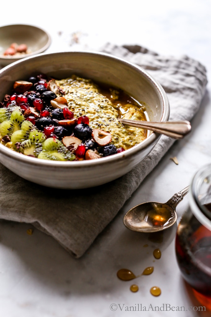 Overnight Turmeric Chia Oats in a bowl with a spoon ready for sharing.
