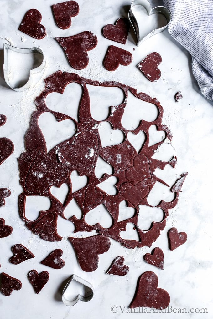Cutting the Vegan Dark Chocolate Shortbread dough with heart shape cookie cutters. 