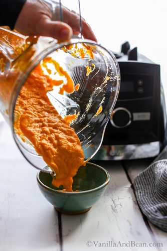 Pouring the Roasted Habanero Carrot Salsa into a bowl. 