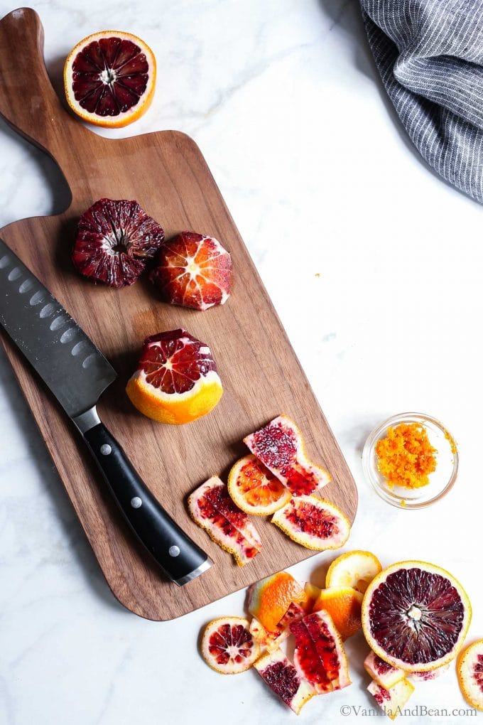 Supremed blood oranges on a cutting board
