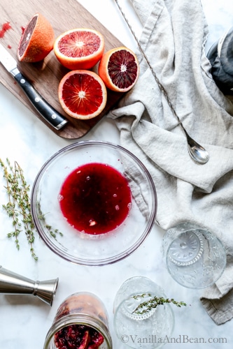 Juiced blood oranges with juice in a bowl. 