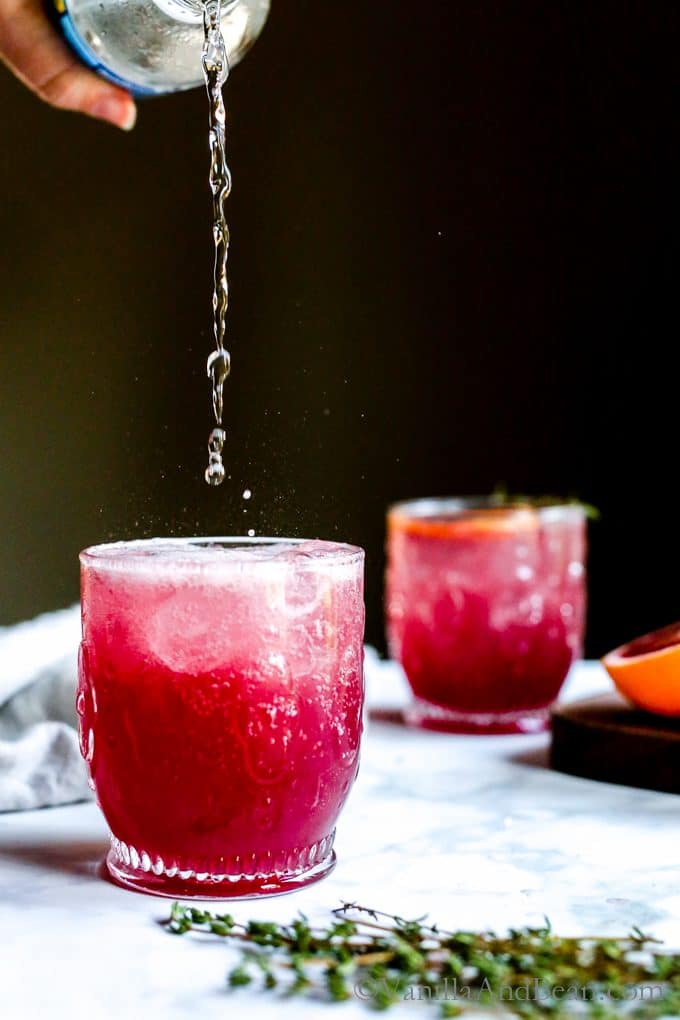 Pouring bubbly into the blood orange cocktail. 
