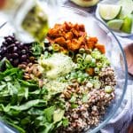 Sweet Potato Quinoa bowl with black beans with dressing poured over the top