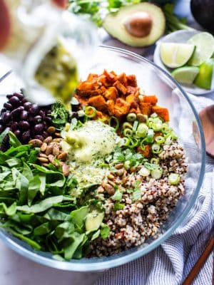 Sweet Potato Quinoa bowl with black beans with dressing poured over the top
