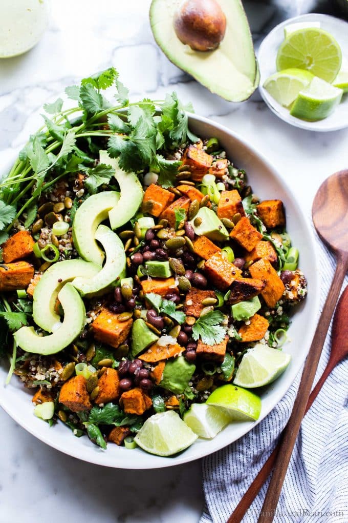 Sweet Potato Quinoa Salad in a bowl with spoons on the side ready to eat. 