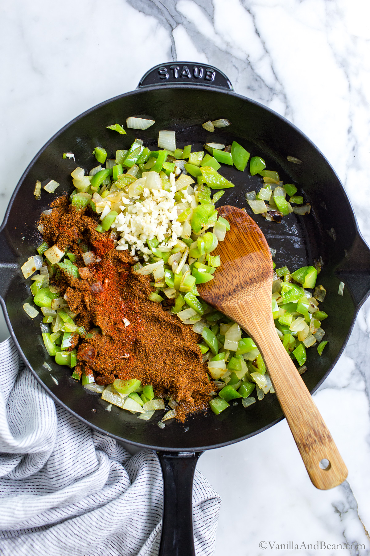 Onions, bell pepper and seasonings in a skillet, the base for vegetarian lentil sloppy joes.