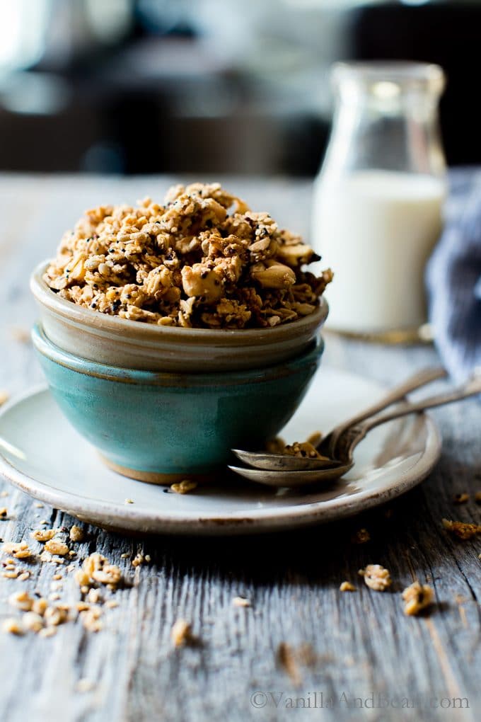 Lemon Tahini Cashew Granola in two bowls with spoons and milk on the side. 