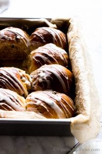 Hot Cross Buns with Rum Soaked Currants drizzled with glaze.