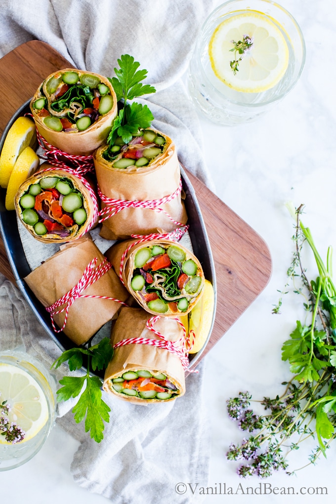 Asparagus Wraps with Whipped Avocado Sun-Dried Tomato Spread in a serving tin. 