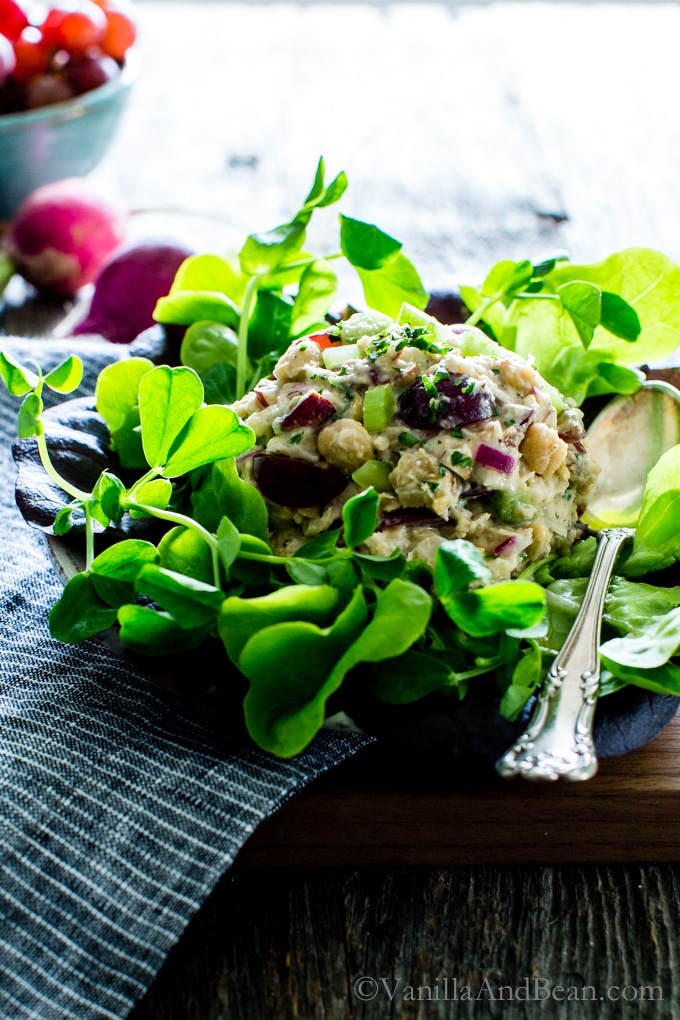 Smashed Chickpea Salad with Pecans and Grapes on a bed of lettuce ready for sharing. 