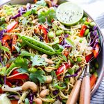 Sesame Noodle Salad in a bowl with serving spoons on the side.